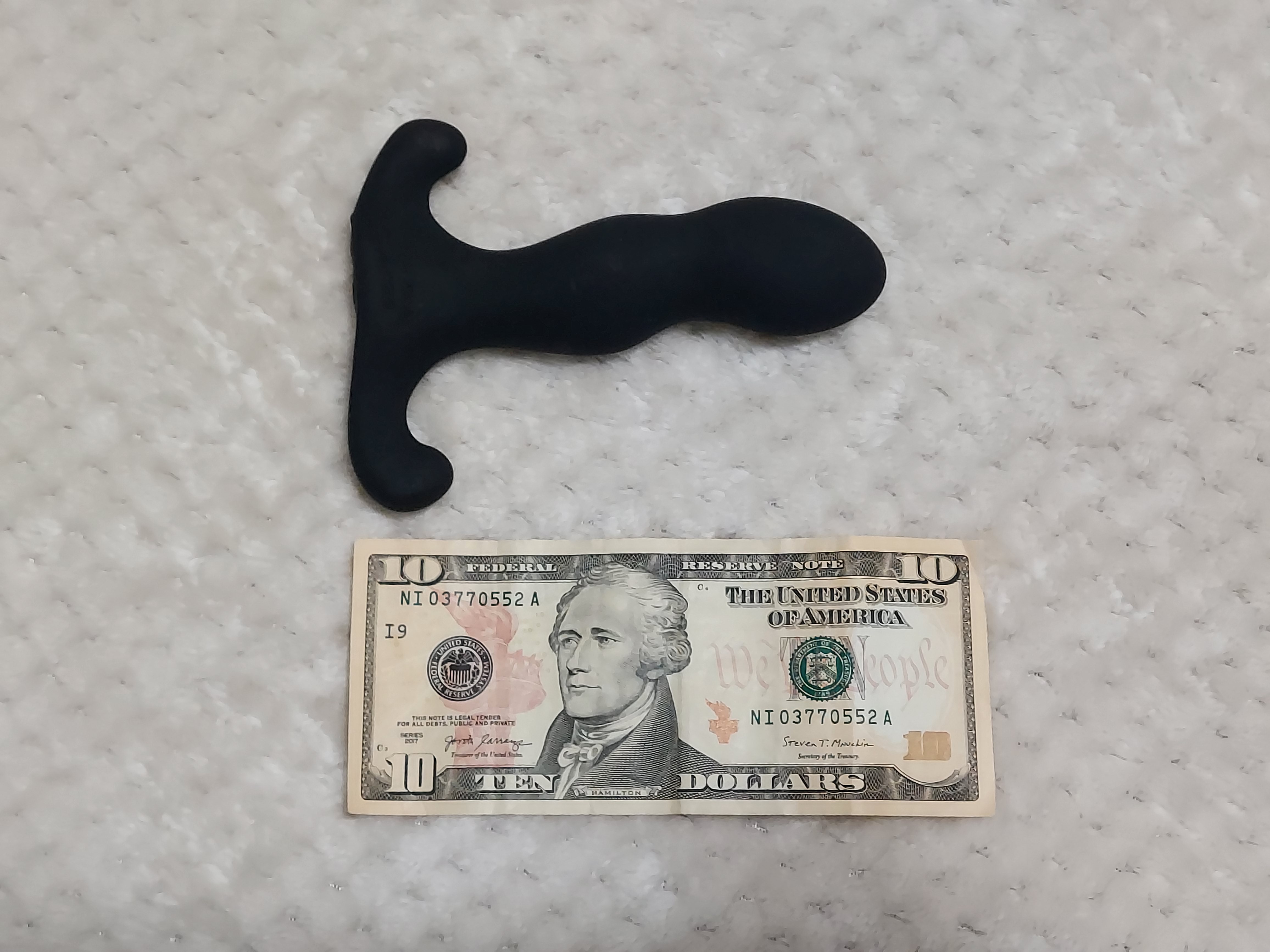 Aneros Vice 2 prostate stimulator next to $10 for size comparison